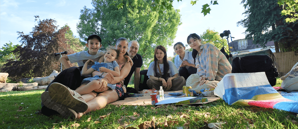 Families and designers sitting together on a picnic blanket during a ShoreQuest activity.